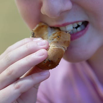 Young girl - child eating candy and sweets. Detail of face and mouth. Concept for healthy lifestyle - healthy - unhealthy sweet food and sugar.