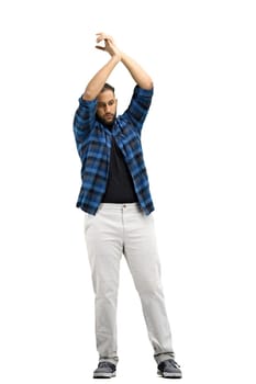 A man, full-length, on a white background, claps.