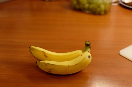 Beautiful fresh yellow banana on the table. Healthy food - fruit for a snack.