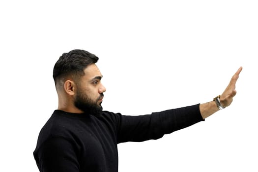 A man, close-up, on a white background, shows a stop sign.