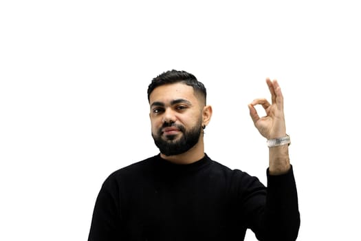 A man, close-up, on a white background, shows an ok sign.