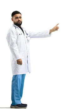 The doctor, in full height, on a white background, shows a forbidding sign.
