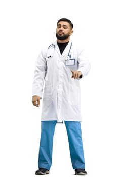 The doctor, in full height, on a white background, shows a forbidding sign.