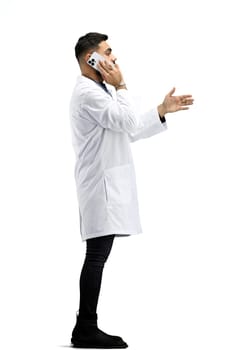 The doctor, in full height, on a white background, talking on the phone.