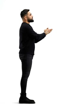 A man, in full height, on a white background, claps.