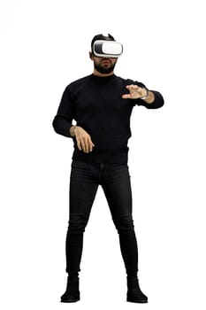 A man, full-length, on a white background, wearing VR glasses.