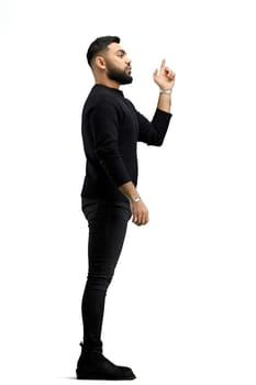 A man, in full height, on a white background, points to the side.