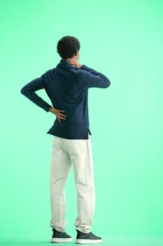 A man, full-length, on a green background, warming up.