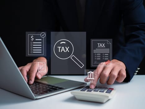 Businessman using a computer to complete Individual income tax return form online for tax payment. financial research, report. Calculation tax return.