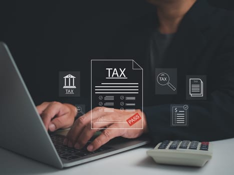 Businessman using a computer to complete Individual income tax return form online for tax payment. financial research, report. Calculation tax return.