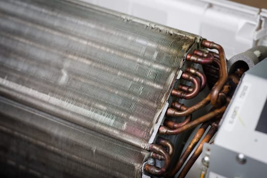 Air conditioning service, repair & maintenance concept. closeup at an indoor unit coil.