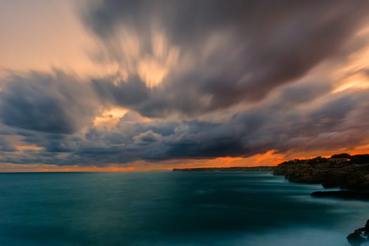 long exposure ,Panoramic view of the sea against the cloudy sky during sunset in the Mediterranean Sea. Mallorca,Balearic Islands,Spain.