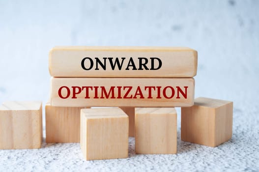 Onward optimization text on wooden blocks. Operational excellence concept.