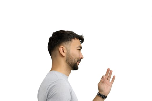 A man, on a white background, in close-up, shows an ok sign.