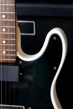 Electric guitar on the background of a guitar amplifier. Musical instrument.