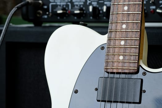 Electric guitar on the background of a guitar amplifier. Musical instrument.