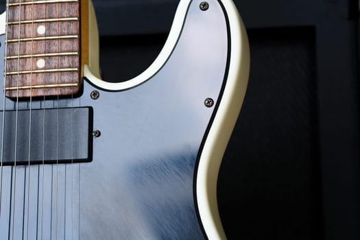 Electric guitar on the background of a guitar amplifier. Musical instrument.