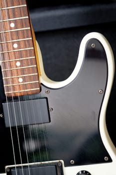 Electric guitar on the background of a guitar amplifier. Musical instrument.