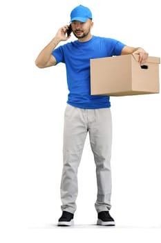 The deliveryman, in full height, on a white background, with a box and a phone.