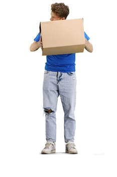 The deliveryman, in full height, on a white background, examines the box.