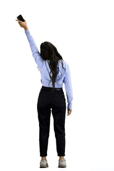 A woman, full-length, on a white background, waving her phone.