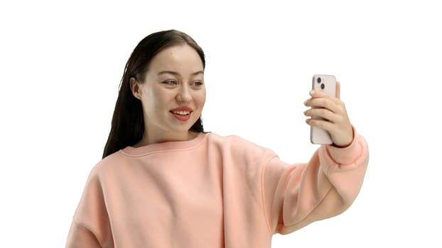 Woman, close-up, on a white background, using a phone.