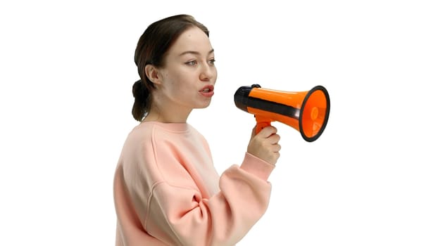 Woman, close-up, on a white background, with a megaphone.