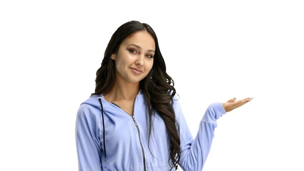 A woman, close-up, on a white background, points to the side.