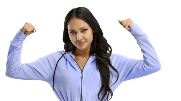 A woman, close-up, on a white background, shows strength.