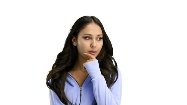 A woman, close-up, on a white background, thinks.