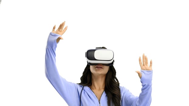 Woman, close-up, on a white background, wearing VR glasses.