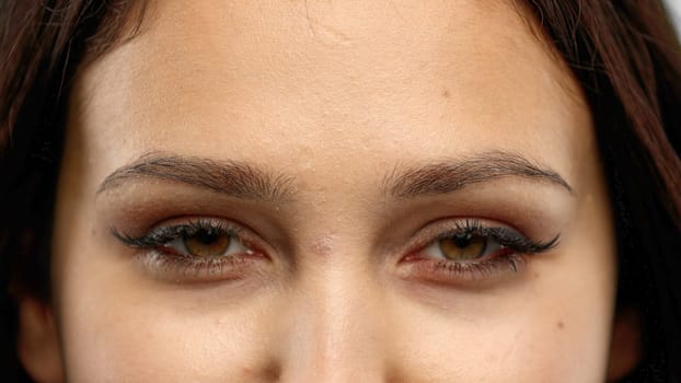 Woman's eyes, close-up, on a white background.