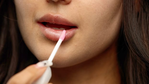 Woman's mouth, close-up, on a white background.