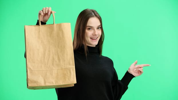 Woman, close-up, on a green background, with bags.