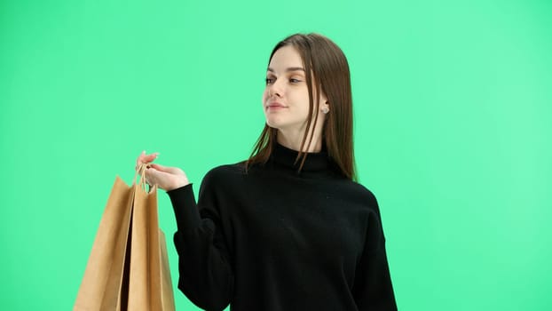 Woman, close-up, on a green background, with bags.