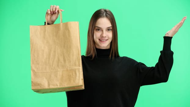 Woman, close-up, on a green background, with bags.