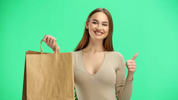 Woman, close-up, on a green background, with bags.