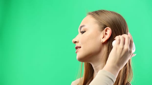 Woman's face, close-up, on a green background.