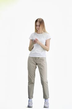 A woman, full-length, on a white background, uses a phone.