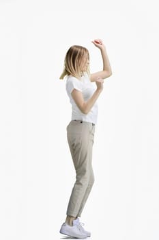 A woman, full-length, on a white background, dancing.