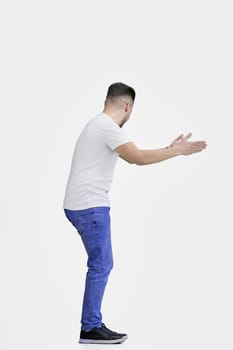 A man, full-length, on a white background, spreads his arms.