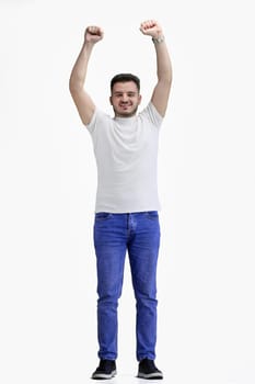 A man, full-length, on a white background, raised his hands up.
