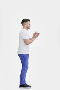 A man, full-length, on a white background, claps.