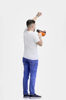 A man, full-length, on a white background, with a megaphone.