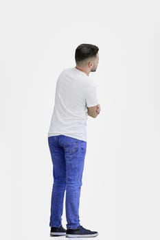 A man, full-length, on a white background, crossed his arms.