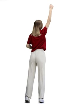 A woman, full-length, on a white background, raised her hand up.