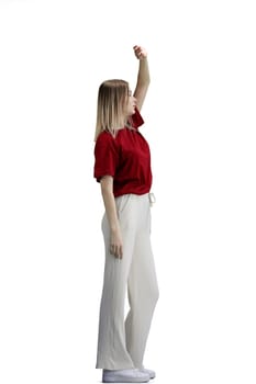 A woman, full-length, on a white background, raised her hand up.
