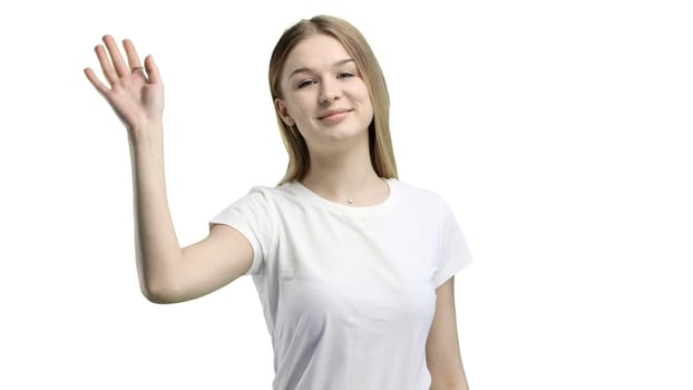 A woman, close-up, on a white background, waving her hand.