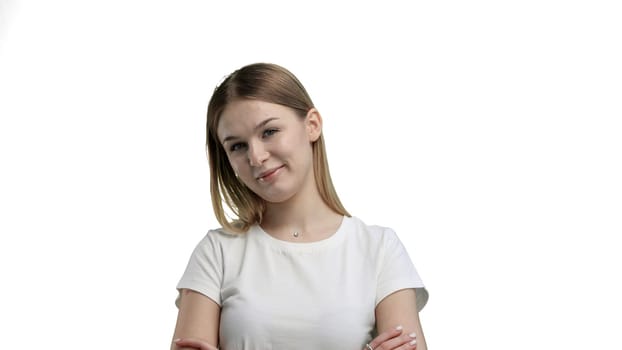 A woman, close-up, on a white background, crossed arms.