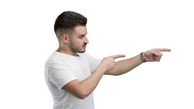 A man, close-up, on a white background, points to the side.